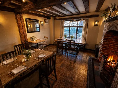 Candlelit dining tables in the beamed Kings Arms snug