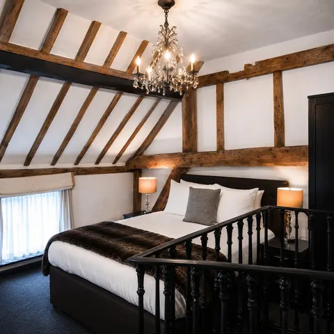 Family suite with exposed roof beams, chandelier and wooden balustrade