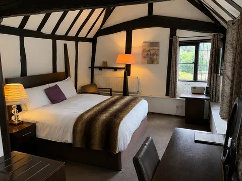Heritage bedroom with exposed beams and a double bed
