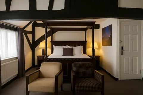 Junior suite with a double bed and two upholstered armchairs